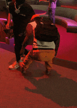 a man wearing a black shirt with the word bucks on it kicks another man