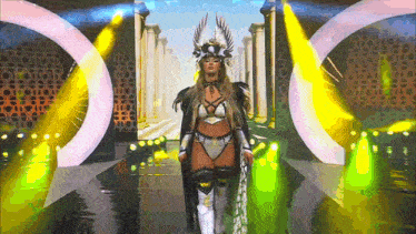 a woman in a viking costume is walking down a stage