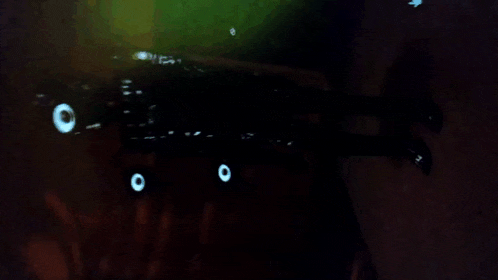 a blurred image of a dark room with a few lights on