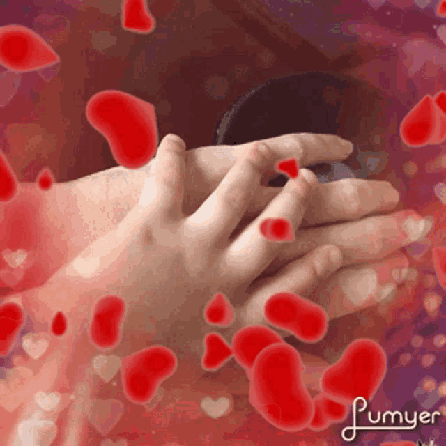 a picture of a person holding another person 's hand with red hearts coming out of it and the word lumyer on the bottom