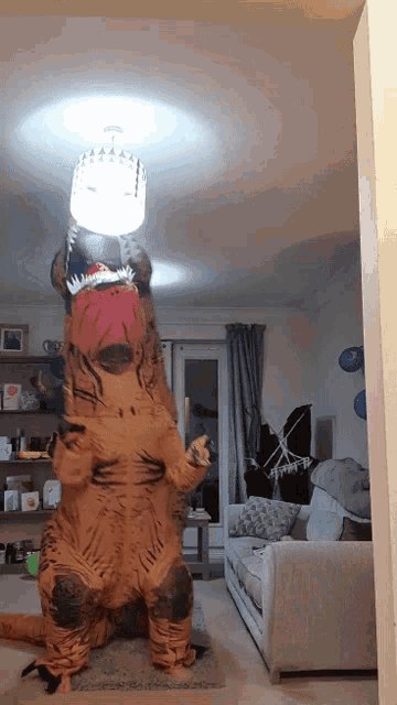 a person dressed in a t-rex costume is holding a light