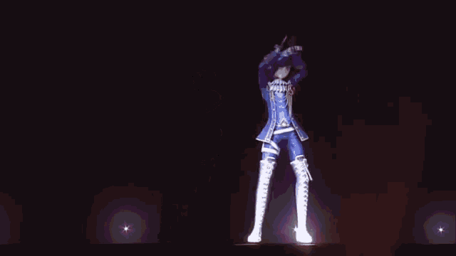 a person is dancing on a stage in the dark .