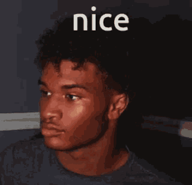a close up of a man 's face with the word nice above him