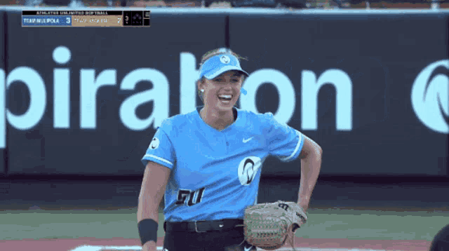 a woman in a blue jersey is standing in front of a sign that says pirates