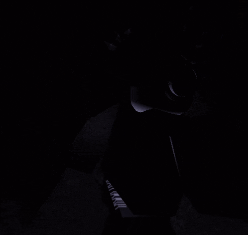 a dark room with a light coming out of a doorway