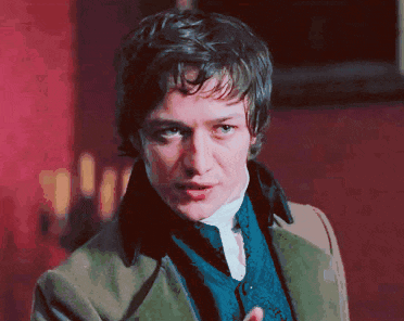 a man wearing a green jacket and a blue vest