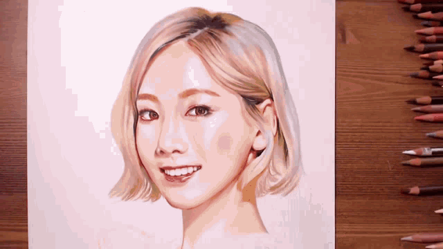a drawing of a woman with short blonde hair is on a wooden table next to colored pencils