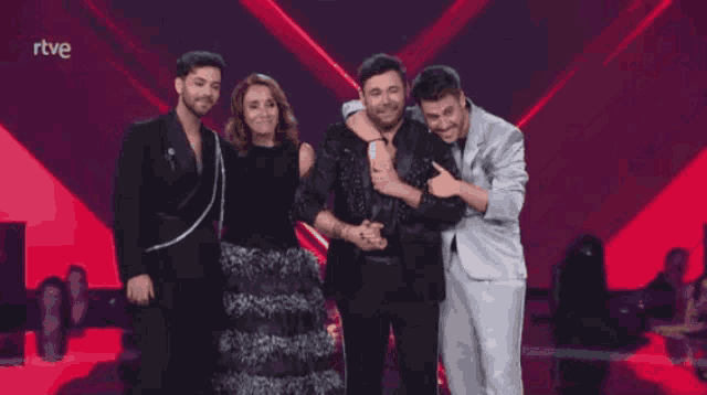 a group of people standing on a stage with rtve written on the bottom right