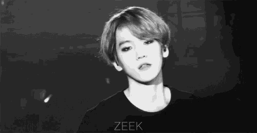 a black and white photo of a young man with the name zeek on the bottom right