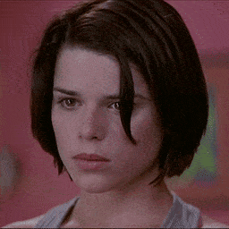 a close up of a woman 's face with short brown hair
