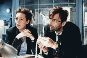 a man and a woman are looking at something together