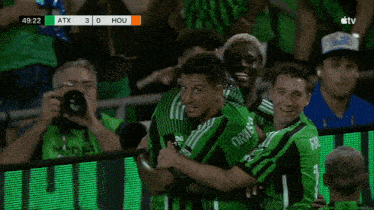 a group of soccer players wearing green jerseys with the word yet on it