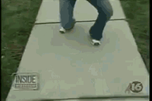 a person is walking down a sidewalk with a sign that says inside polling .