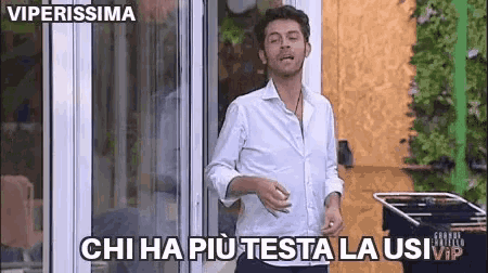 a man in a white shirt is standing in front of a glass door and says " viperissima " on the bottom