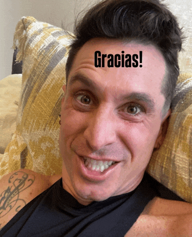 a man laying on a couch with the word gracias on his forehead