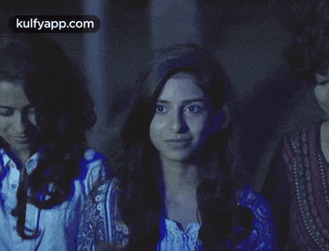 three girls are standing in a dark room with the words kulfyapp.com in the corner