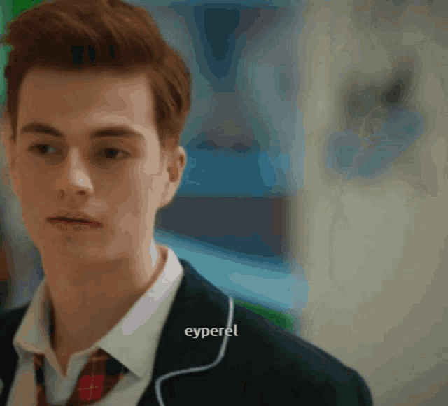 a young man in a suit and tie has the word eyperel on the bottom