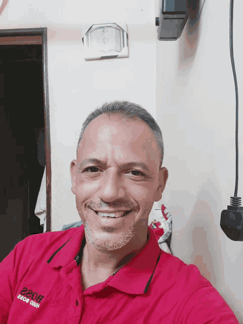 a man wearing a red shirt that says 2208 on the front