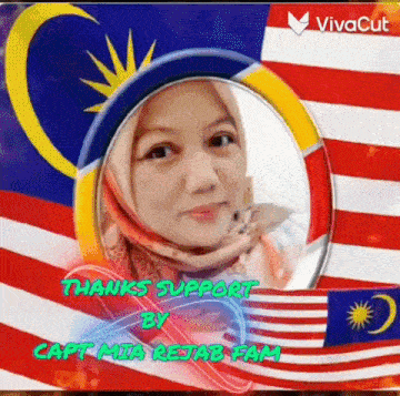 a woman in a hijab is standing in front of a flag .