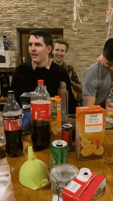 a box of tesco orange nectar sits on a wooden table