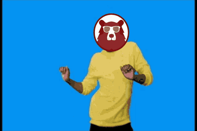 a man wearing a yellow shirt with a bear head on it