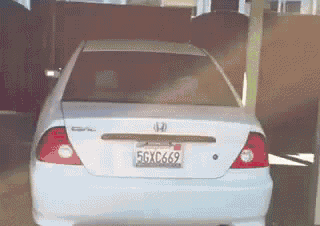 a white honda civic with a license plate that says 5gxc669