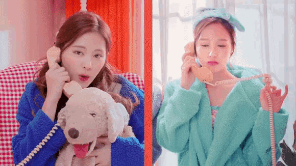 a woman is holding a stuffed dog while talking on a phone .