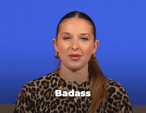a woman wearing a leopard print shirt has the word badass written on her face