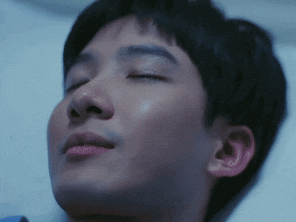 a close up of a man 's face with his eyes closed and his mouth open