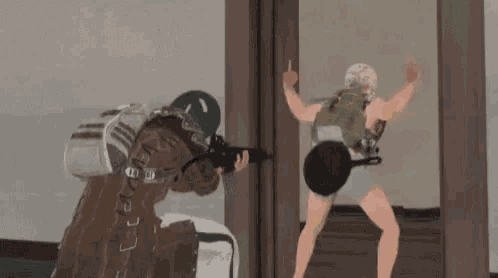 a man is holding a gun while a woman is holding a frying pan .