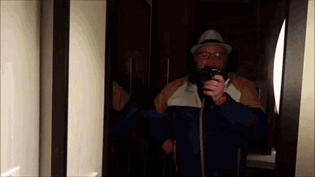 a man taking a picture of himself in a mirror with a sony camera
