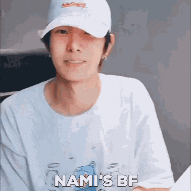 a young man wearing a white hat and a white shirt says nami 's bf
