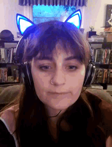 a woman wearing headphones and a headband with cat ears on her head