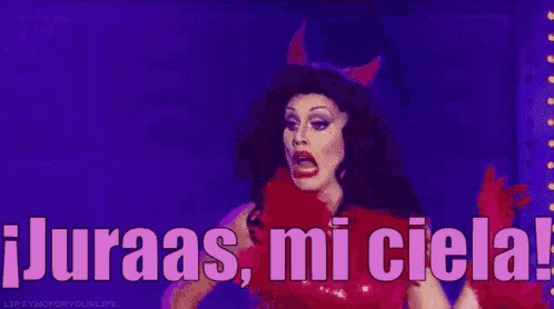 a drag queen is wearing a devil costume and says juraas mi ciela !