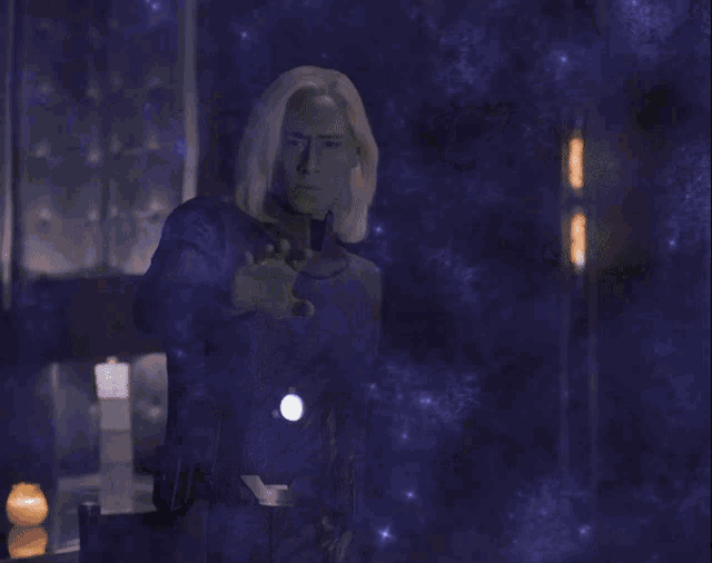 a person is standing in front of a glowing object