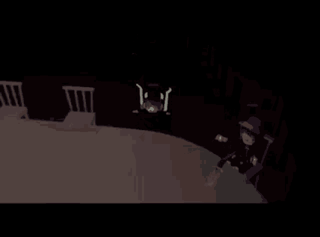 a person is holding a sword in a dark room .
