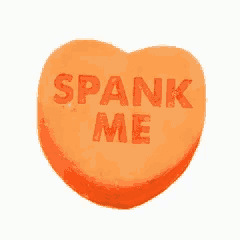 a heart shaped candy with the words spank me written on it