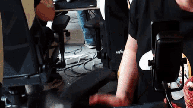 a man wearing a black shirt that says " evolve " on it