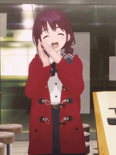 a girl in a red coat is laughing and covering her mouth with her hands