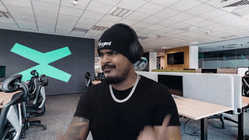 a man wearing headphones and a beanie that says diggyard on it