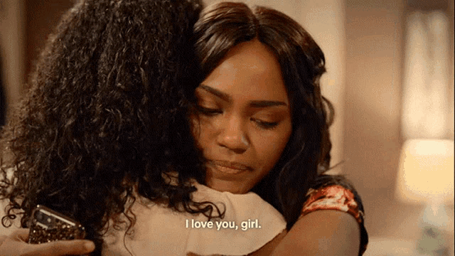 a woman hugging another woman with the words i love you girl