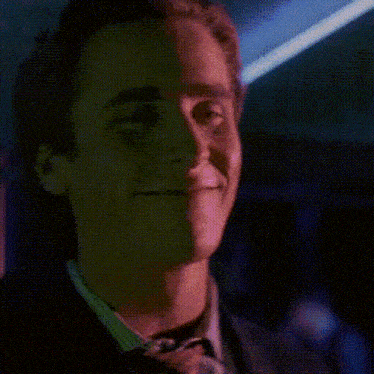 a man in a suit and tie is screaming with his mouth open .