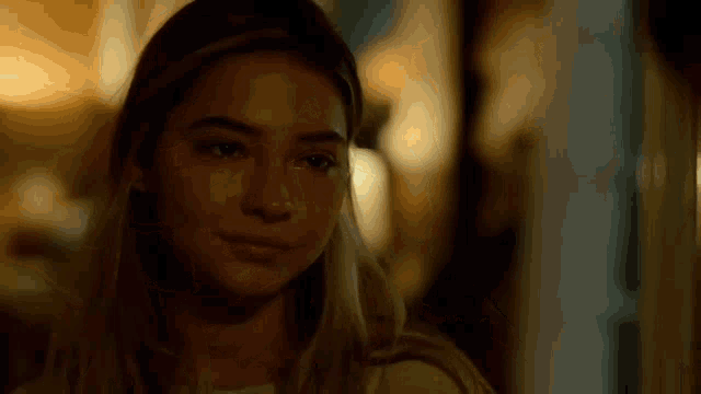 a close up of a woman 's face with a blurred background .
