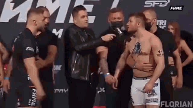 a group of men are standing next to each other on a stage .