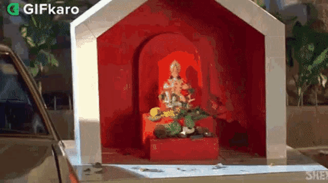 a small shrine with a statue of ganesha in the back of a car .