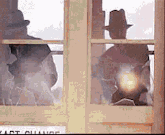 two men in hats are looking out a window with a sign that says east county on it