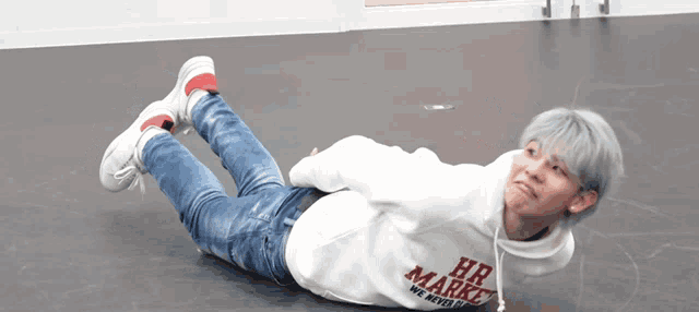 a man wearing a white hoodie that says hr market on it