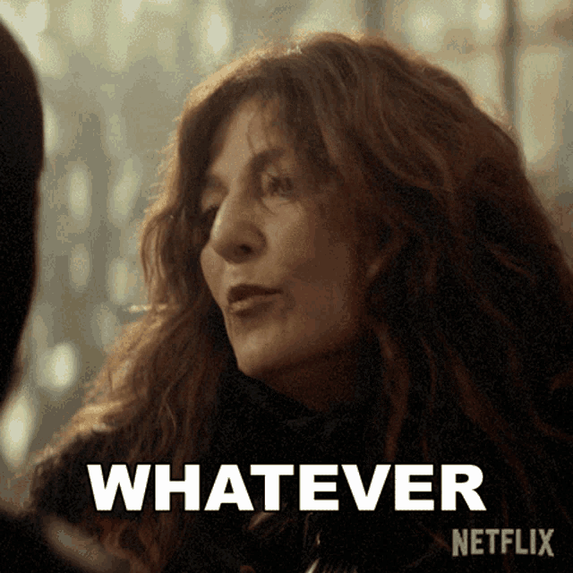 a close up of a woman 's face with the words " whatever " on the bottom