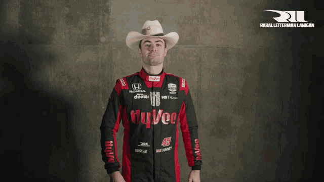 a man wearing a cowboy hat and a race suit with the number 46 on it