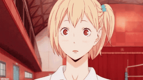 a girl with blonde hair and a blue star in her hair looks at the camera